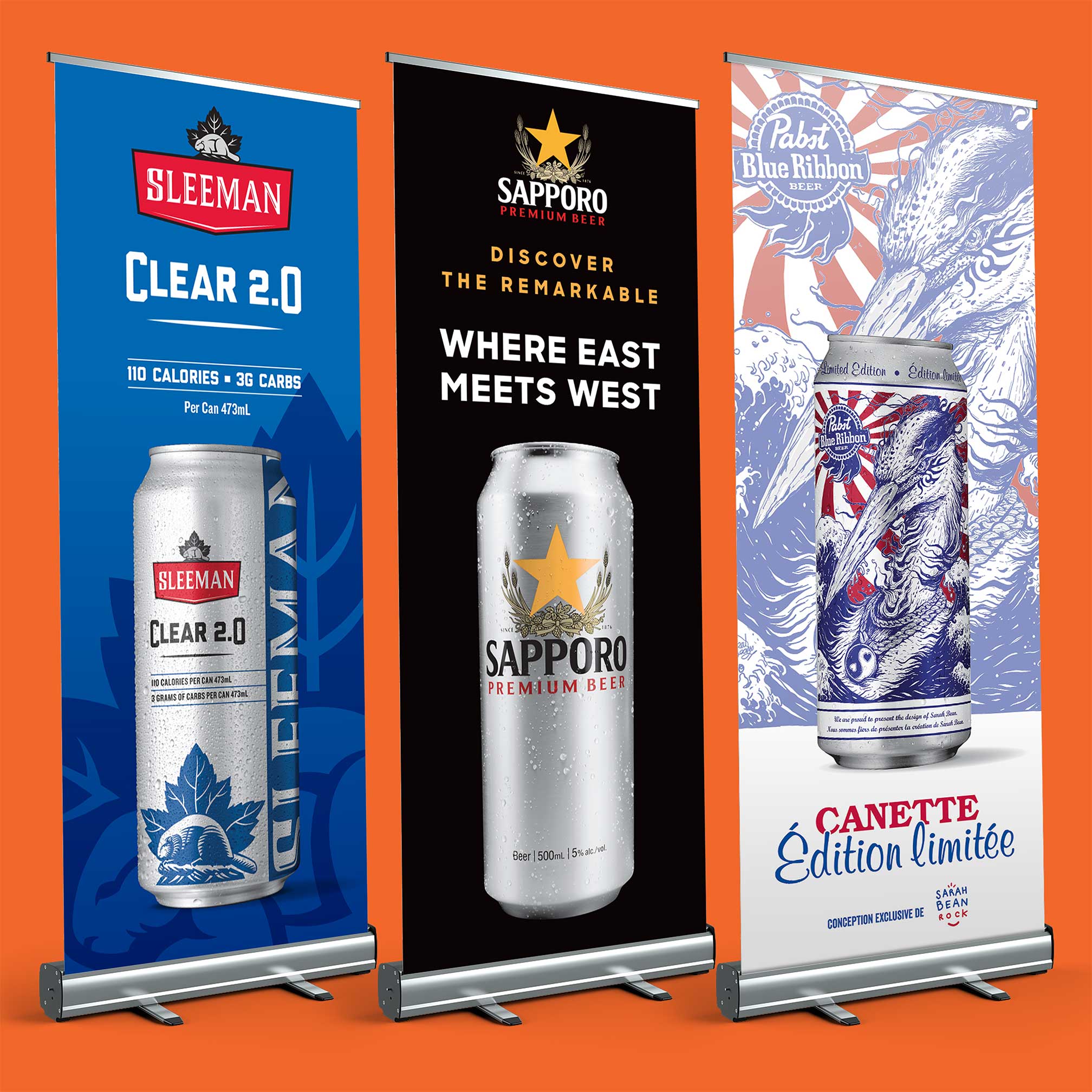 Custom pull-up banners featuring beverage brands and promotional messaging for retail environments.