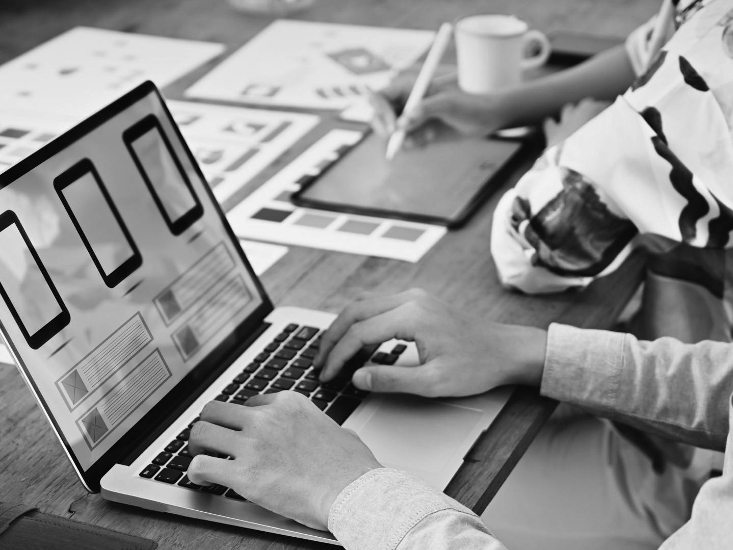 Professional workspace with design materials, devices and production tools used for creative development.