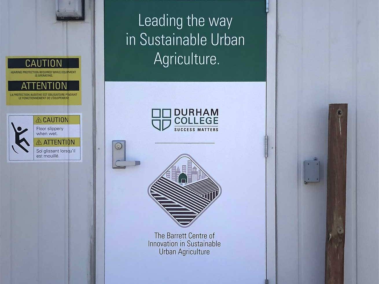 Office door covered with custom printed graphics and branded messaging.