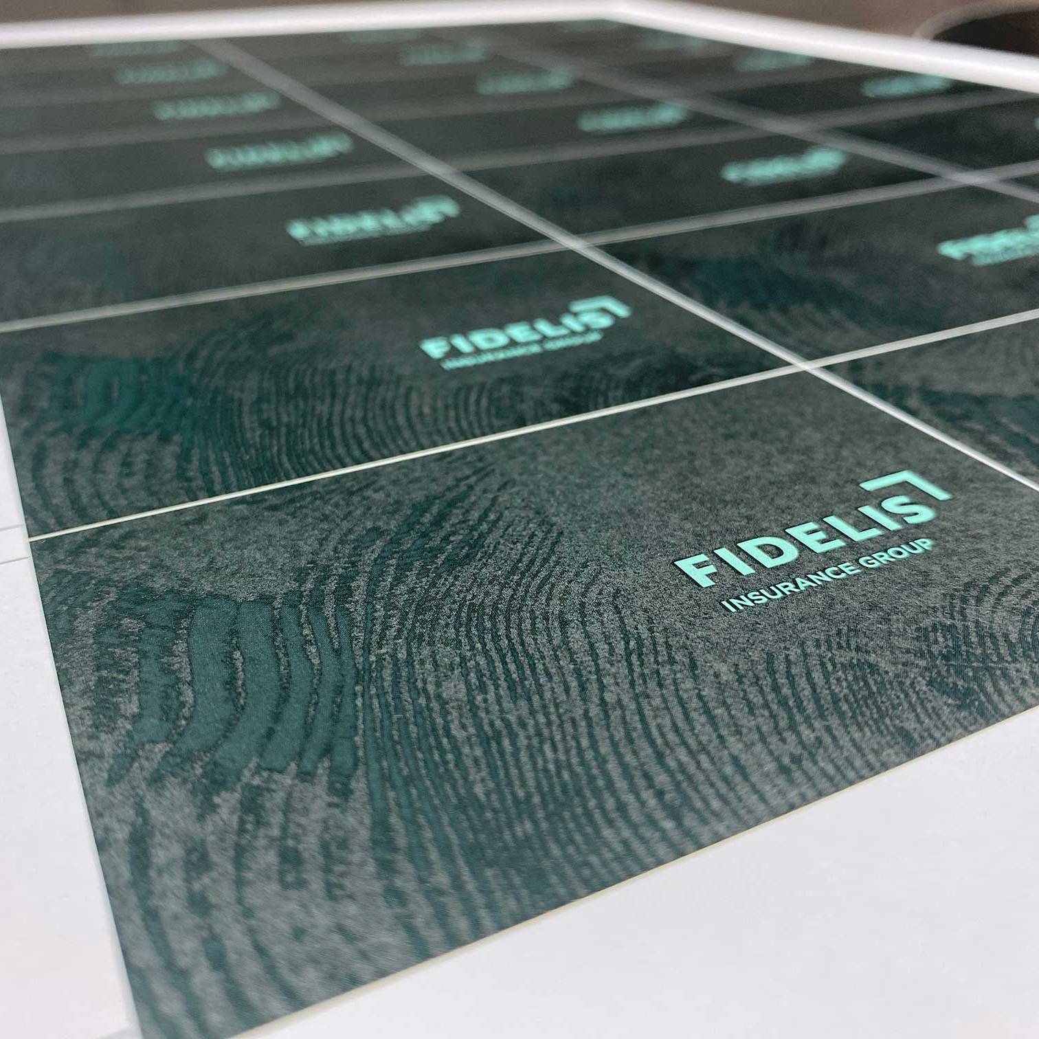 Premium dark green business cards featuring custom digital printing, typography and textured finishing.