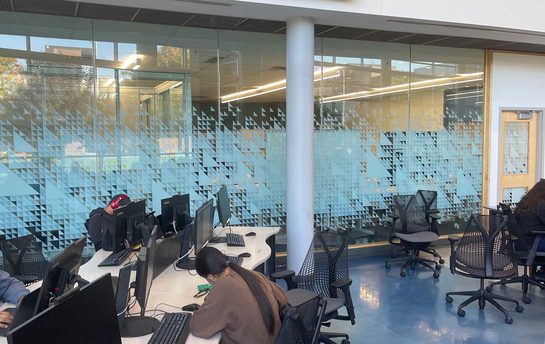 Corporate glass walls featuring custom large-format frosted privacy and decorative graphics.