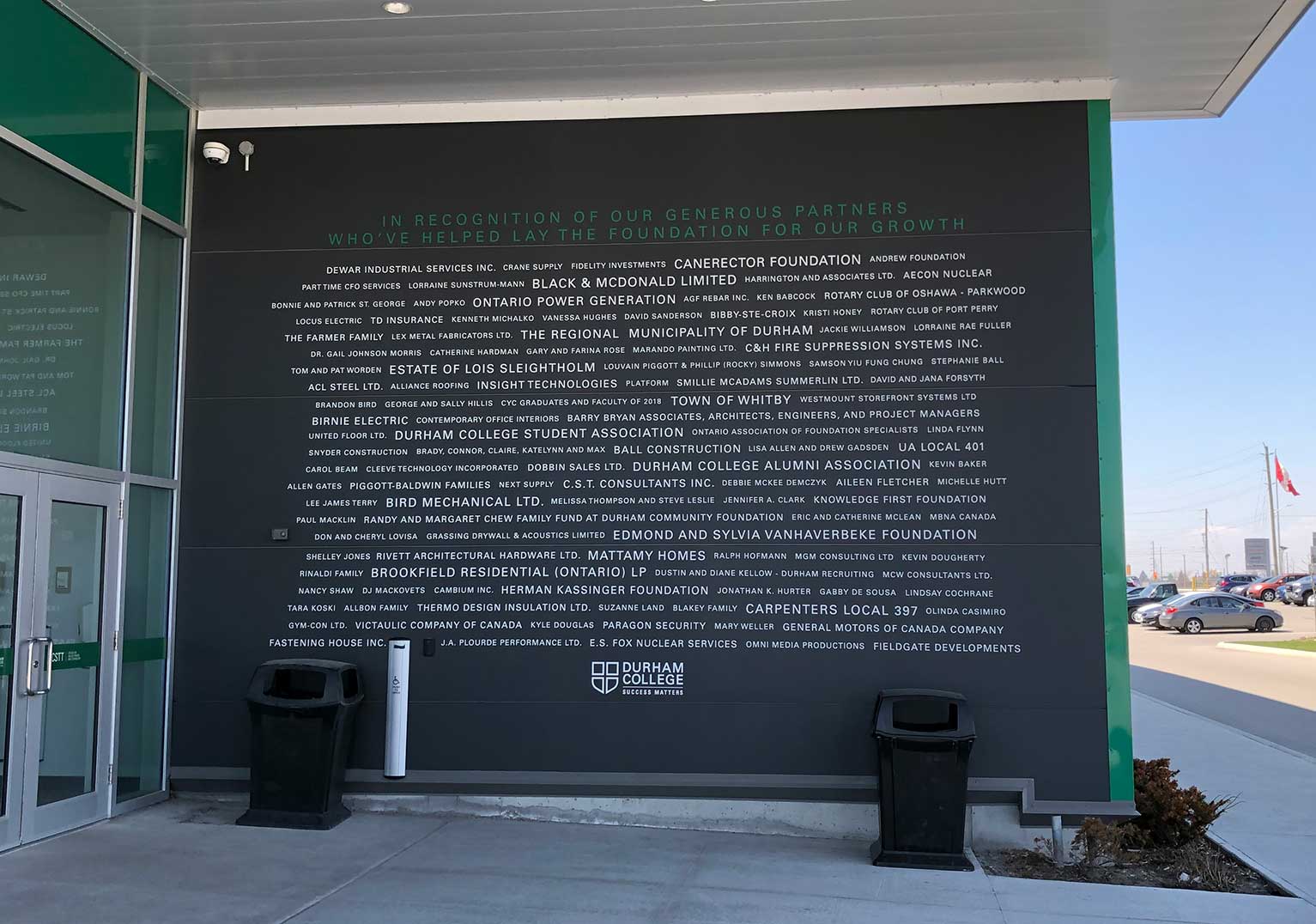 Custom large-format typography and corporate storytelling graphics installed across an office wall.
