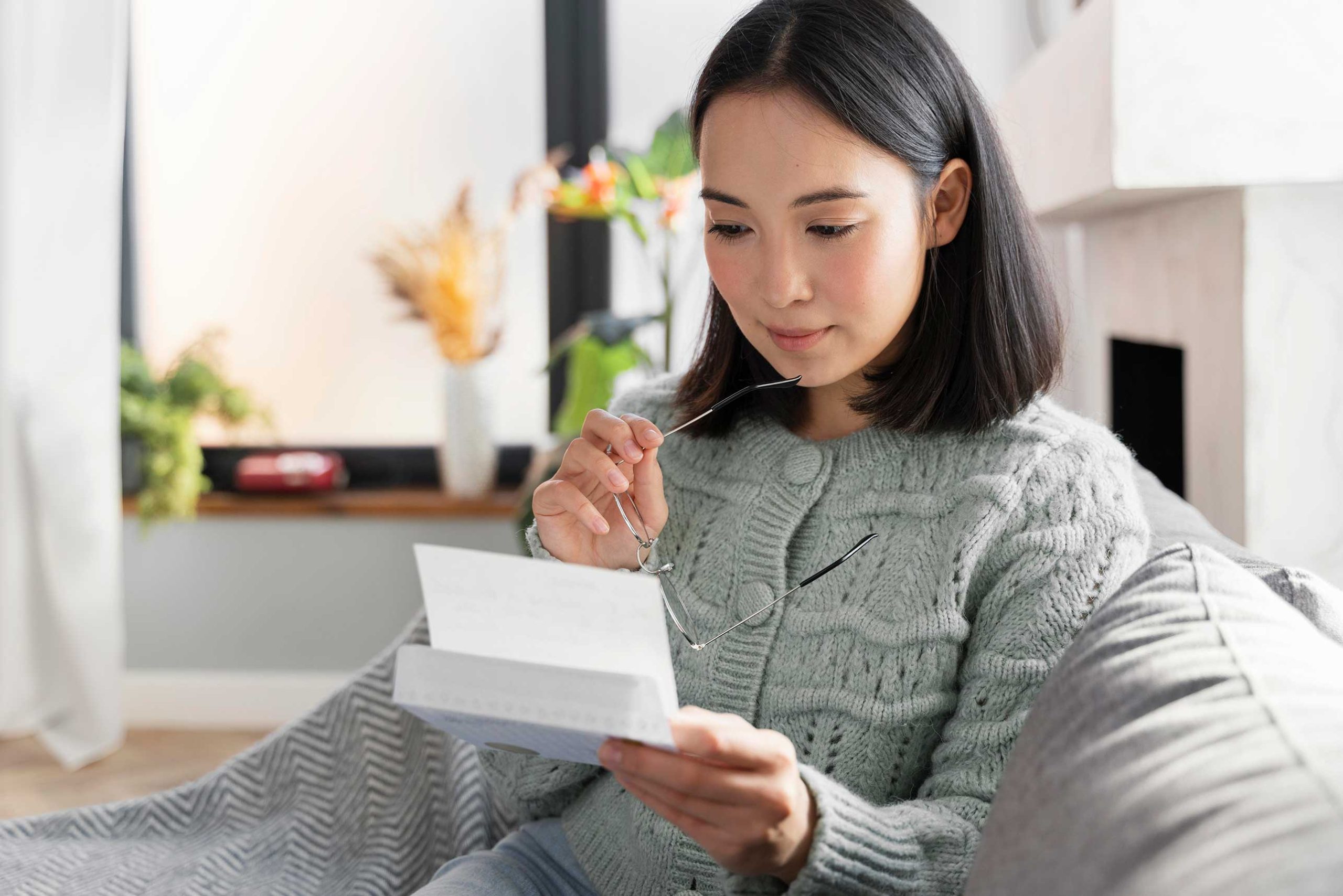 Customer reading a personalized marketing letter illustrating targeted direct mail communications.